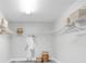 Bright walk-in closet with shelving, storage baskets, and a hanging rod for clothes at 2431 Murray Pass, Odessa, FL 33556