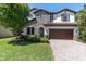 Beautiful two story home with stone accents, lush lawn, and a paver driveway at 2431 Murray Pass, Odessa, FL 33556