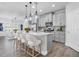 Chic kitchen with stainless steel appliances, pendant lighting, and a large island at 2431 Murray Pass, Odessa, FL 33556