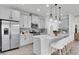 Modern kitchen features stainless steel appliances, gray cabinets, countertop island and stylish pendant lighting at 2431 Murray Pass, Odessa, FL 33556
