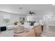 Bright living room with a sectional sofa, ceiling fan, stylish decor, and modern furniture at 2431 Murray Pass, Odessa, FL 33556