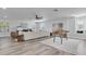 Open-concept living area with a large sectional sofa, ceiling fan, and stylish decor at 2431 Murray Pass, Odessa, FL 33556