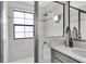 Elegant glass enclosed shower with tiled walls, showerhead, and window providing natural light at 2431 Murray Pass, Odessa, FL 33556