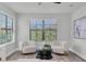 Cozy sitting area with lots of natural light and two comfortable chairs at 2431 Murray Pass, Odessa, FL 33556