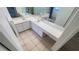 Bathroom featuring double sinks, a long countertop and tiled floor at 2538 Indigo Dr, Dunedin, FL 34698