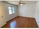 Bright bedroom with hardwood floors and a window overlooking the surrounding landscape at 2538 Indigo Dr, Dunedin, FL 34698
