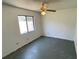 Cozy bedroom featuring a ceiling fan and a window overlooking the backyard at 2538 Indigo Dr, Dunedin, FL 34698