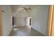 Light-filled bedroom with tile floors, ceiling fan, and view of the entryway at 2538 Indigo Dr, Dunedin, FL 34698
