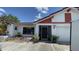 Exterior view of a single-story home featuring a well-manicured lawn and a driveway at 2538 Indigo Dr, Dunedin, FL 34698