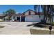 Charming single-story home with a well-maintained lawn, driveway, and a two-car garage at 2538 Indigo Dr, Dunedin, FL 34698