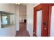 Foyer with tile flooring, mirrored accent and a view into the living room at 2538 Indigo Dr, Dunedin, FL 34698