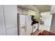 Bright kitchen with tile flooring, white cabinets, and matching appliances at 2538 Indigo Dr, Dunedin, FL 34698