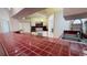 Cozy kitchen featuring vibrant red tile countertops and essential appliances at 2538 Indigo Dr, Dunedin, FL 34698