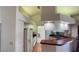 Open kitchen featuring white appliances, tile floors, and a red tiled breakfast bar at 2538 Indigo Dr, Dunedin, FL 34698