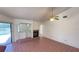 Cozy living room with fireplace, tile floors, and access to screened patio at 2538 Indigo Dr, Dunedin, FL 34698