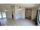 Spacious living area with tile floors and access to the outdoor pool area at 2538 Indigo Dr, Dunedin, FL 34698