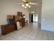 Living room with tile floors, ceiling fan, and view to the back patio and pool area at 2538 Indigo Dr, Dunedin, FL 34698