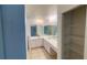 Well-lit main bathroom featuring double sinks, a large mirror, and ample counter space at 2538 Indigo Dr, Dunedin, FL 34698