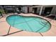 A serene pool with screened enclosure and covered patio area at 2538 Indigo Dr, Dunedin, FL 34698