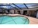Enjoy this sparkling pool with steps and a spacious screened enclosure at 2538 Indigo Dr, Dunedin, FL 34698