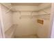 Practical walk-in closet with metal shelving for optimal organization and storage at 2538 Indigo Dr, Dunedin, FL 34698