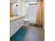 Bright bathroom with white cabinets, granite countertops, and a shower-tub combo at 2924 Windridge Dr, Holiday, FL 34691