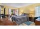 Cozy bedroom with a queen-sized bed, sliding glass doors to a patio, and wood-look flooring at 2924 Windridge Dr, Holiday, FL 34691