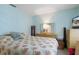 Inviting bedroom with a large bed, blue walls, and lots of natural light at 2924 Windridge Dr, Holiday, FL 34691