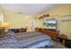Bright bedroom with yellow walls, a patterned bedspread, and furnishings, creating a comfortable retreat at 2924 Windridge Dr, Holiday, FL 34691