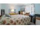 Comfortable bedroom with a queen bed, blue walls, and natural light at 2924 Windridge Dr, Holiday, FL 34691