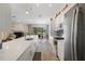 Modern kitchen with white cabinetry, stainless steel appliances, and open-concept design at 2924 Windridge Dr, Holiday, FL 34691