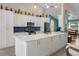 Modern kitchen with sleek white cabinetry, stainless steel appliances, and a stylish blue backsplash at 2924 Windridge Dr, Holiday, FL 34691