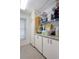 Functional laundry room featuring white cabinets, countertop, and window for natural light at 2924 Windridge Dr, Holiday, FL 34691