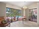 Bright living area with tiled floors, leading to an outdoor pool and seating area at 2924 Windridge Dr, Holiday, FL 34691