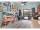 Bright living space boasts lots of natural light, open layout, and access to the pool deck at 2924 Windridge Dr, Holiday, FL 34691