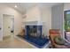 Cozy sitting room with blue tiled fireplace, comfortable seating, and access to the lanai at 2924 Windridge Dr, Holiday, FL 34691
