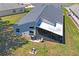 Aerial view of a home showing the backyard, screened patio, and landscaping at 312 Barrington Ct, Spring Hill, FL 34609