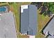 Aerial view of the home with its roof, landscaping and neighboring pool at 312 Barrington Ct, Spring Hill, FL 34609