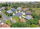 Aerial view of homes in a cul-de-sac, surrounded by mature trees and lawns at 312 Barrington Ct, Spring Hill, FL 34609