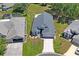 Aerial view of the property featuring the house, lawn, driveway, and neighboring homes at 312 Barrington Ct, Spring Hill, FL 34609