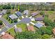 Aerial view of a home in a cul-de-sac, surrounded by mature trees and lawns at 312 Barrington Ct, Spring Hill, FL 34609