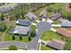 An aerial view of a home in a cul-de-sac, surrounded by trees and greenery at 312 Barrington Ct, Spring Hill, FL 34609