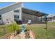 Inviting backyard space features a screened patio and landscaping at 312 Barrington Ct, Spring Hill, FL 34609
