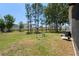 Backyard with mature trees and a screened patio at 312 Barrington Ct, Spring Hill, FL 34609