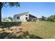 Backyard view of the home with a screened patio and a well-maintained lawn at 312 Barrington Ct, Spring Hill, FL 34609