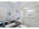 Bathroom showcasing a large mirror above the sink and a bathtub with glass doors at 312 Barrington Ct, Spring Hill, FL 34609
