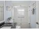Bathroom featuring a bathtub with glass doors and a view of the sink area at 312 Barrington Ct, Spring Hill, FL 34609