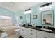 Well-lit bathroom features double sinks, white cabinetry, a soaking tub, and modern fixtures at 312 Barrington Ct, Spring Hill, FL 34609