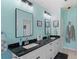 Bright bathroom featuring a double sink vanity with black countertop and black framed mirrors at 312 Barrington Ct, Spring Hill, FL 34609