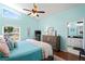 Bright bedroom with en suite bathroom, wood floors, and a large window overlooking the yard at 312 Barrington Ct, Spring Hill, FL 34609